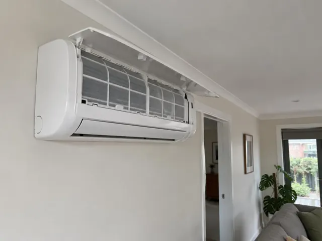Open split system with clean filters on a light wall in a living room in Blair Athol